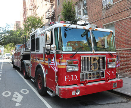 New York, NY, USA - August 25, 2025:  FDNY fire truck parked on a street near a brick building