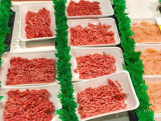 Neatly packaged ground meat (mince) and chicken in a supermarket display in Surabaya, Indonesia....