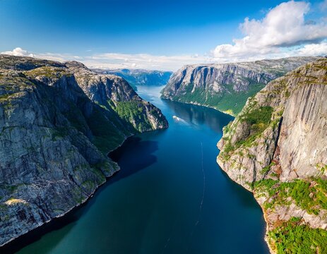 a breathtaking drone aerial view of a norwegian fjord showcasing towering cliffs lush greenery and the crystal clear waters of the fjord kjerag lysebotn lysefjorden norway