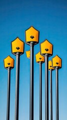 A Cluster of Yellow Pedestrian Crossing Signs Against a Vibrant Blue Sky