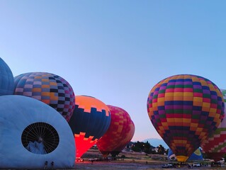 Beautiful colorful hot air balloons photo image ready to fly in blue clear sky over amazing valleys...