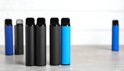 Several vaping devices displayed on a surface