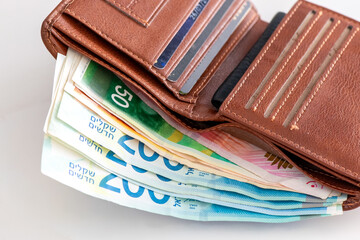 Leather wallet with  banknotes and credit cards.