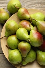 Fresh ripe pears on wooden table, flat lay