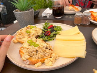 Delicious omelet toasts, a rich brunch plate consisting of cheese and salad.