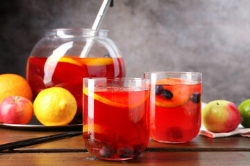 Tasty punch and fruits on wooden table. Refreshing drink
