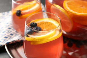 Fruity punch on black table, closeup. Refreshing drink