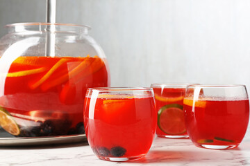 Fruity punch on white marble table, closeup. Refreshing drink