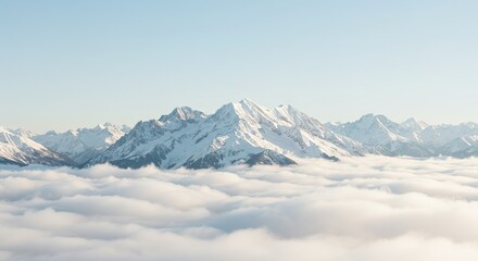 Obraz premium Snowcovered mountains rise above a sea of white clouds against a light blue sky