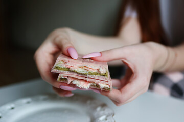 Creative close up of chocolate bar layers, pink coating with green filling.