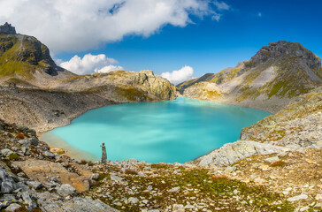 Captivating landscape of Pizol Wildsee lake in the Swiss Alps, featuring tranquil turquoise water...