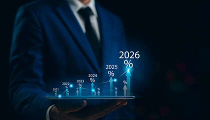 New Year 2026 Business start-up to goals, A businessman touches taps start-up button 2025 to 2026 for New Year 2026, sets goals, for develops strategies to achieve better results success in the future