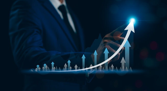A Businessman hand touching analyzing Business growth graph finance data stock bar chart Hologram trade currency investment on city background. Business financial stock market concept.