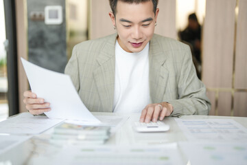 Confident asian business man Auditor or internal revenue service staff checking annual financial...
