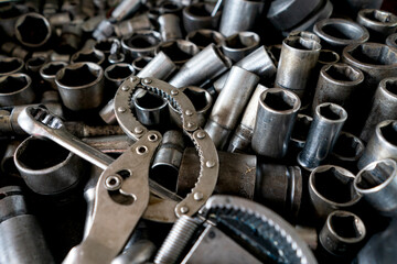 A disorganized assortment of metal tools and hardware components.