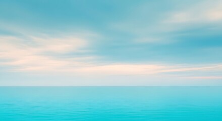 Obraz premium A serene seascape featuring a calm ocean and a cloudy sky, creating a peaceful and relaxing atmosphere