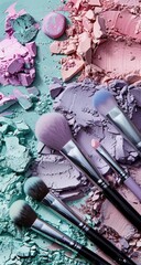 Crushed pastel eyeshadow and makeup brushes on a teal surface