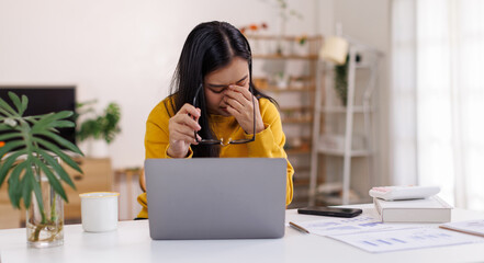 Portrait of a Worried young asian woman using laptop computer at home, Sad, unhappy, Worried, Depression, or employee life stress concept