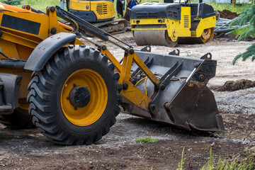 yellow tractor bulldozer at the construction site, construction and landscaping of the urban area