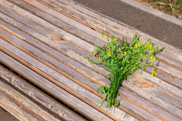 A bouquet of wildflowers on a bench on a summer day