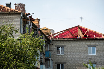 a multi-storey house with a dismantled roof, the roof is being repaired due to strong winds