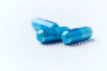 Amino acids capsules on bright background. Soft focus. Close up. Copy space.	