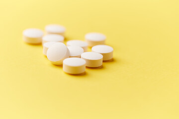 Hyaluronic acid tablets. Hyaluronic acid helps skin stretch and flex and reduces skin wrinkles. Bright paper background. Soft focus. Close up. Copy space	