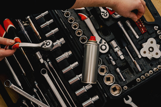 Toolbox with wrenches and aerosol spray can for maintenance