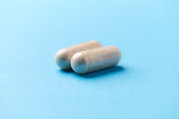 Creatine tablets on paper background. Soft focus. Close up. Copy space.	