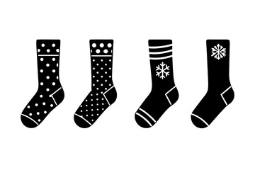 Four black silhouette socks with white patterns including polka dots stripes and snowflakes on white background