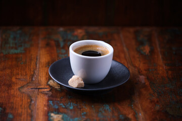 Cup of coffee on rustic wooden background. Soft focus. Copy space	