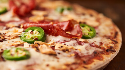 Pizza with salami, mozzarella cheese and jalapeno pepper. Wooden background. Soft focus. Copy space.	