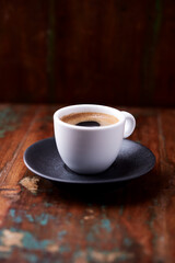 Cup of coffee on rustic wooden background. Soft focus. Copy space	