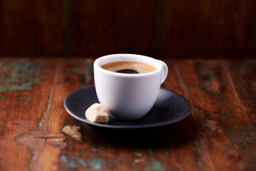 Cup of coffee on rustic wooden background. Soft focus. Copy space	
