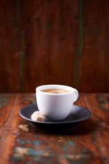 Cup of coffee on rustic wooden background. Soft focus. Copy space	