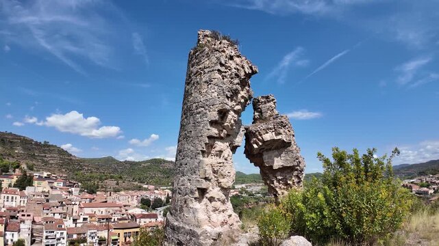 Watch a historic watchtower perched on a hilltop overlooking the city below, with mountains in the distance and a dramatic sky above. Perfect for travel, architecture, and landscape projects.
