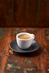 Cup of coffee on rustic wooden background. Soft focus. Copy space	