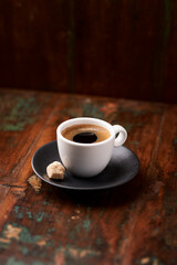 Cup of coffee on rustic wooden background. Soft focus. Copy space	