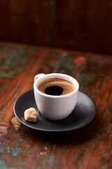Cup of coffee on rustic wooden background. Soft focus. Copy space	