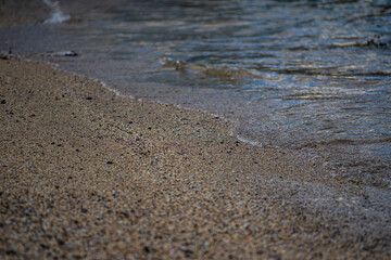Small Gentle Ocean Waves Touching Pebble Beach Shoreline in Iceland