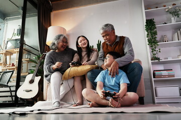 Happy family together playing games, many girls and boys holding joysticks playing games, little...