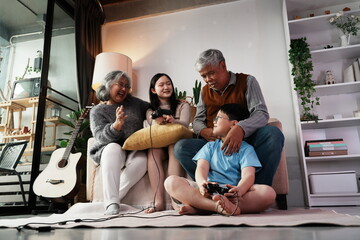 Happy family together playing games, many girls and boys holding joysticks playing games, little...