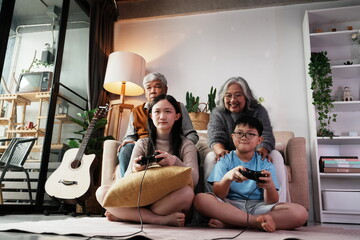 Happy family together playing games, many girls and boys holding joysticks playing games, little...