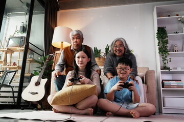 Happy family together playing games, many girls and boys holding joysticks playing games, little...