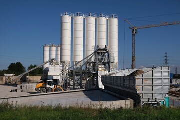 Scenery of concrete factory with white silos for production of concrete	