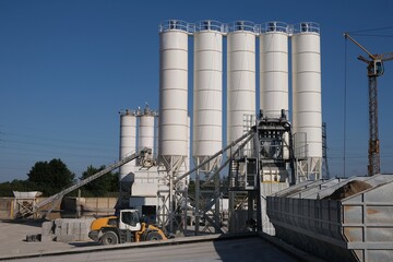 Scenery of concrete factory with white silos for production of concrete	