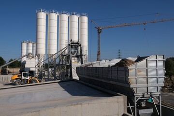 Scenery of concrete factory with white silos for production of concrete	