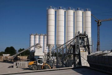 Scenery of concrete factory with white silos for production of concrete	