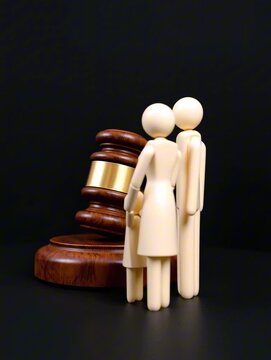 Wooden gavel and family figurines symbolize family law and courtroom decisions in closeup view