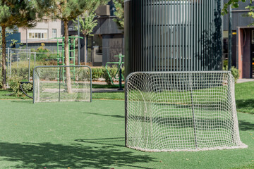 Mini Soccer field with goals on green turf, outdoor play area
